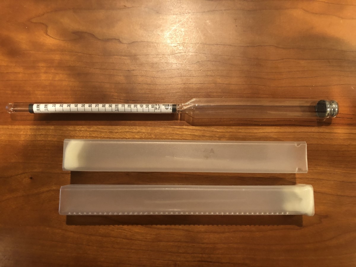 hydometer laying on table, with case