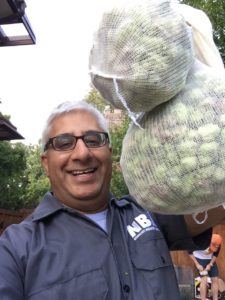 Picture of Chin holding sacks of fresh hops
