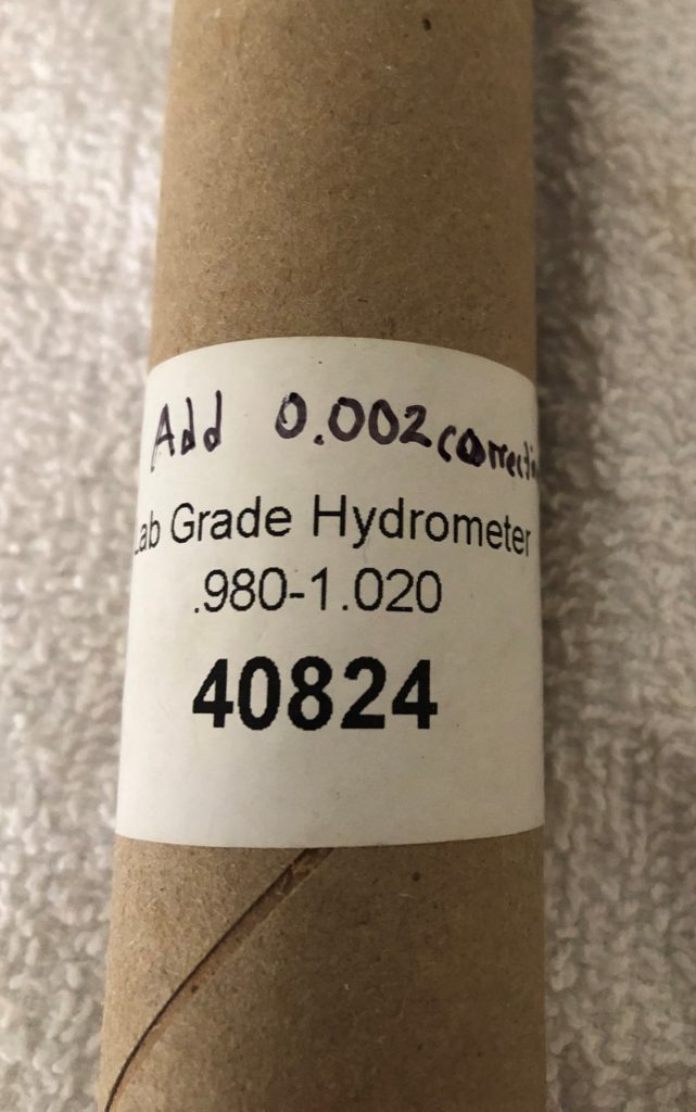Cardboard hydrometer storage tube reading "Add 0.002"