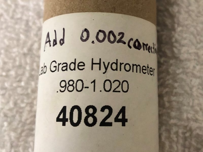 Cardboard hydrometer storage tube reading "Add 0.002"